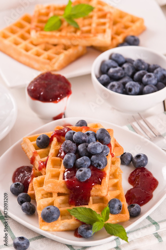 Waffles with blueberries and jam. 