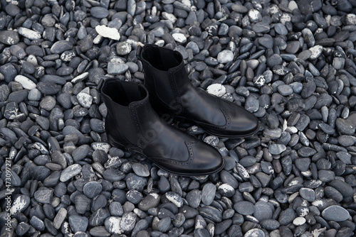 Black boot , Designed black boot, black boot on a stone background, black boot on a special background, black boot on rocks, black boot for woman