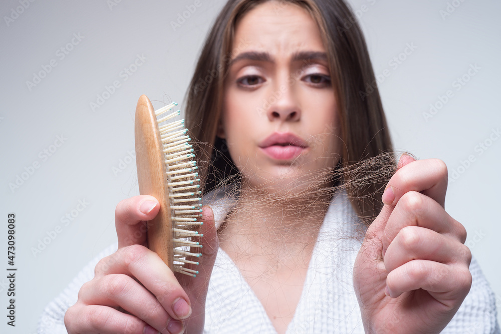 Hair loss woman with a comb and problem hair. Hairloss and bald problems concept. Hair loss woman with a comb and problem hair. Hairloss and bald problems concept.