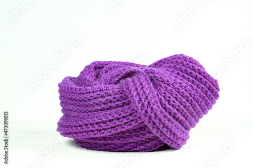 Hand-knitted scarf on a white table Velvet violet