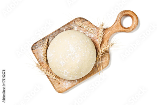 Fresh raw dough for pizza or bread baking on wooden cutting board isolated on white background. top view photo