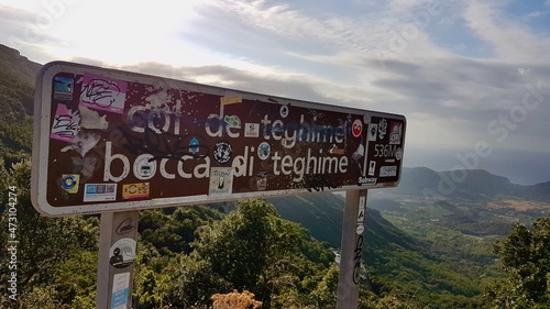 Sign at col de teghime (bocce di teghime), mountain pass and view point in Corsica, France. Aerial view of the vineyards in the Patrimonio hills at sunset. photo