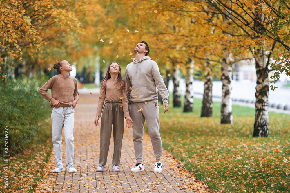 Fototapeta premium Family of dad and kids on beautiful autumn day in the park