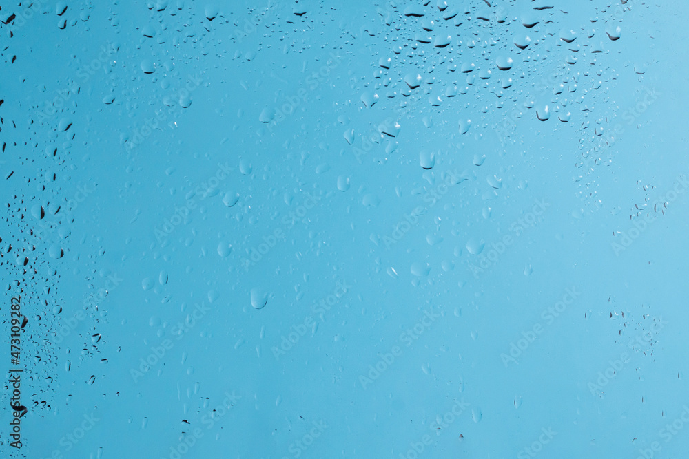 Blue backgrond with water drops. Wet glass.