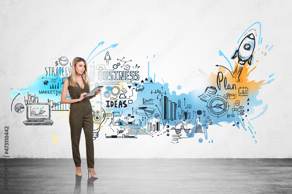 Businesswoman in formal jumpsuit is holding tablet near colourfu Businesswoman in formal jumpsuit is holding tablet near colourfu