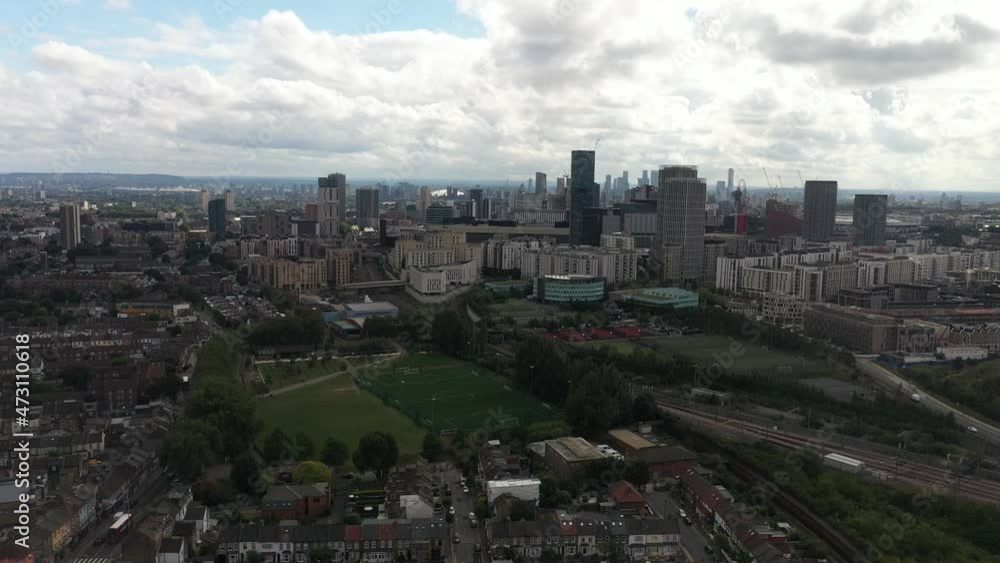 urban neighbourhood and sports area with football pitch. Panoramic shot of high rise apartment buildings. London, UK urban neighbourhood and sports area with football pitch. Panoramic shot of high rise apartment buildings. London, UK