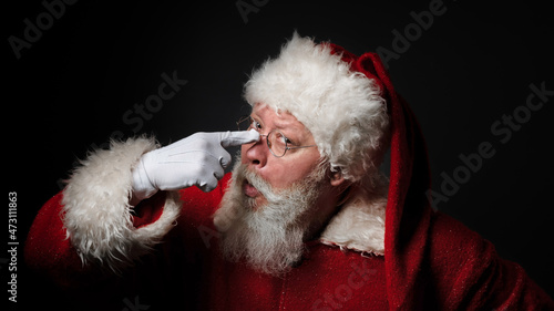 Funny Santa Claus adjusting glasses