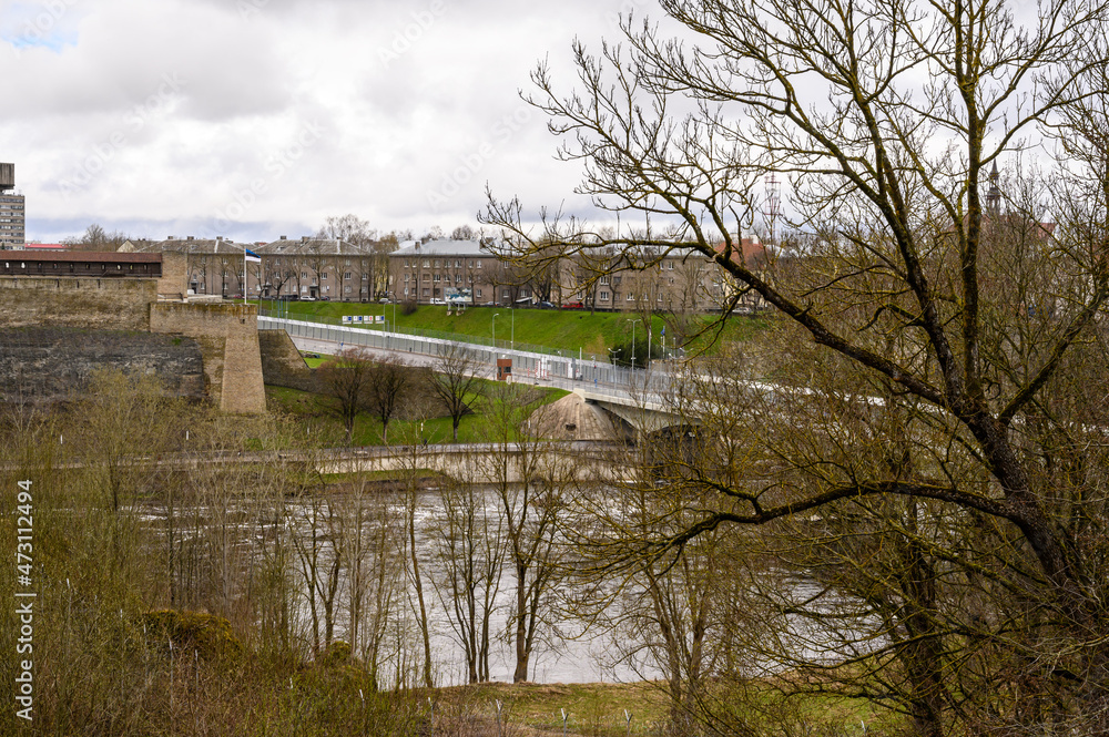 View from the fortress wall to Narva and the bridge that connects Russia and Estonia. State border. Ivangorod fortress. Old fortress walls. Historical sites.