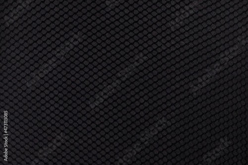 Black fabric background, pattern close up