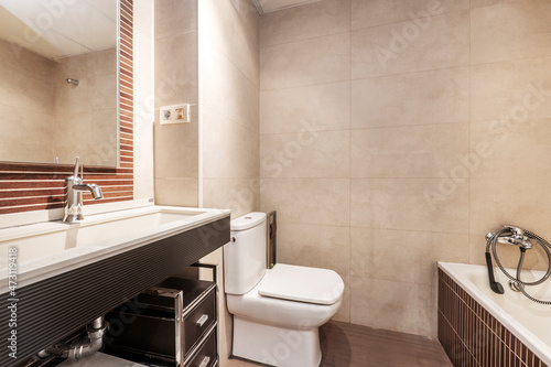 Toilet with white sink and black furniture in vacation rental apartment