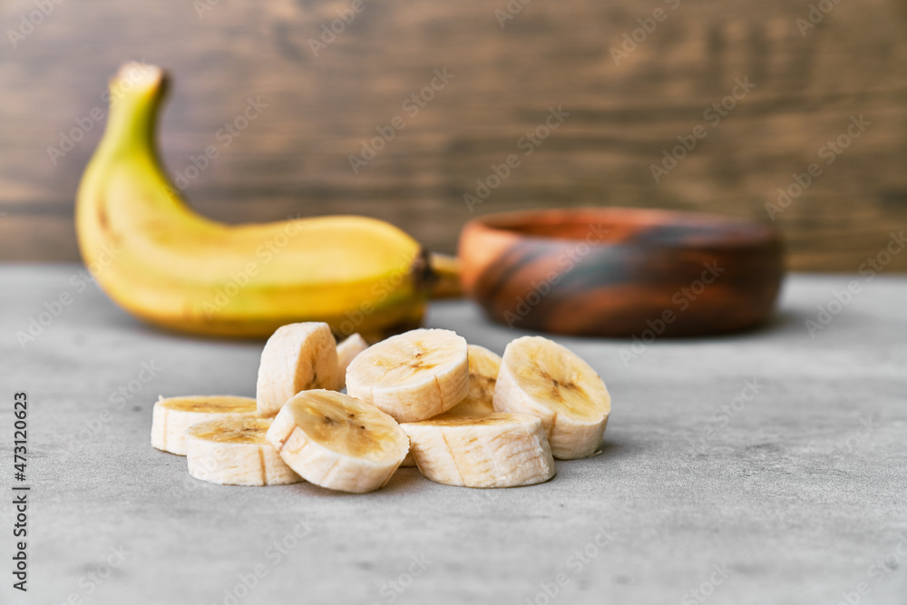 Photo of banana slices on a concrete surface
