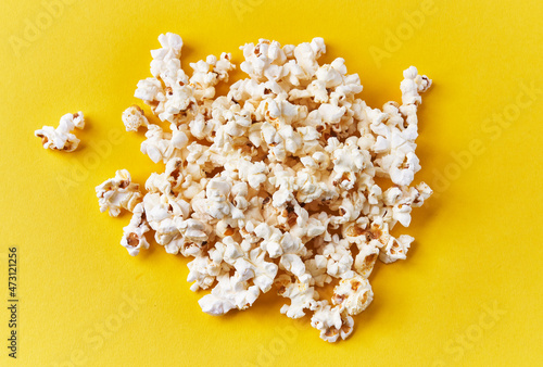  Bunch of salty popcorns on a yellow background