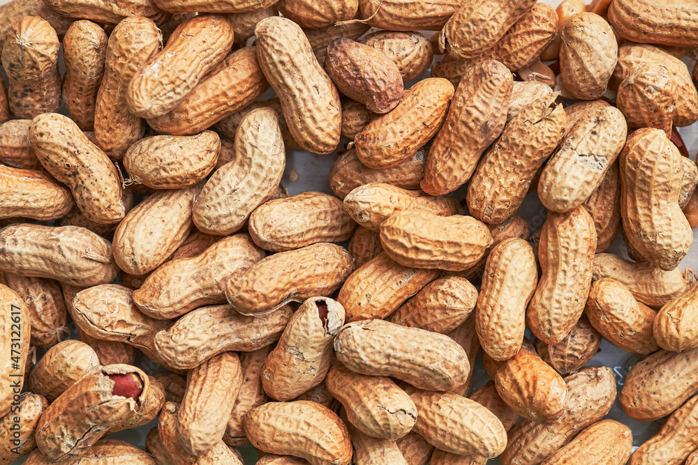 Healthy roasted unpeeled peanuts. Brown nuts texture Healthy roasted unpeeled peanuts. Brown nuts texture
