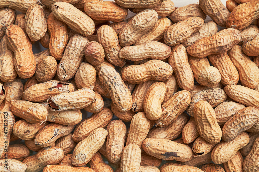 Healthy roasted unpeeled peanuts. Brown nuts texture Healthy roasted unpeeled peanuts. Brown nuts texture