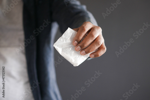 drug addiction concept with hand holding heroine packet on black backgrund 