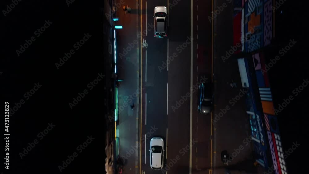 Night city scene, cars driving through evening city. Tracking vehicles from directly above. Passing through streets and crossroads. London, UK Night city scene, cars driving through evening city. Tracking vehicles from directly above. Passing through streets and crossroads. London, UK