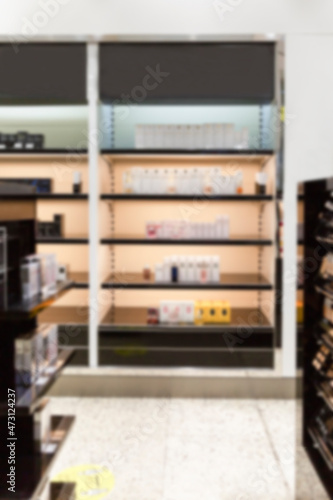 Cabinets with beauty products and perfume in a luxury store. Front view. Blurred. Vertical.