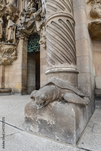 Barcelona, Spain - 22 Nov, 2021: Carved turtle at the base of a column supporting the facade of the Sagrada Familia, Barcelona, Catalonia, Spain