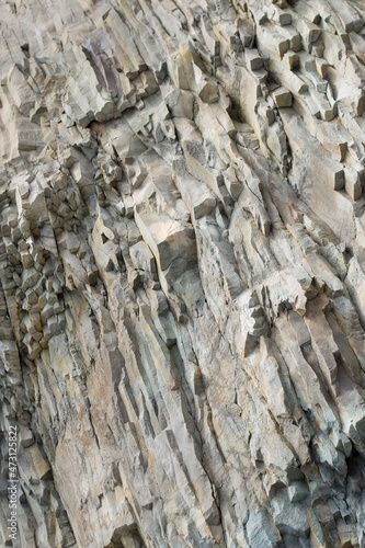 Sheer cliff, cave entrance.