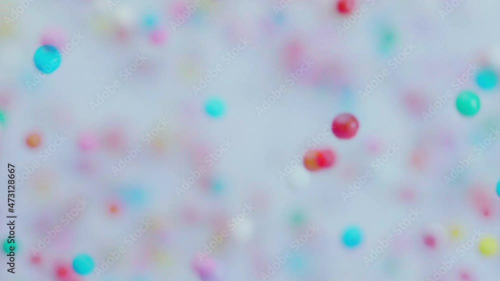 Colorful sprinkles sugar candy fly after being exploded. Slow motion. Close-up shot. Colorful sprinkles sugar candy fly after being exploded. Slow motion. Close-up shot.