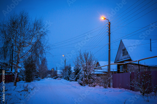 Winter street in the village at dusk