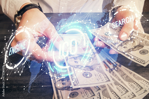 Multi exposure of blockchain theme drawing hologram and USA dollars bills and man hands. Business concept.