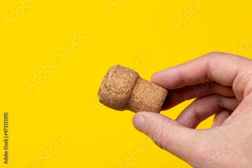 a wine cork in hand close up