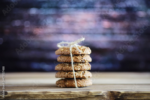 Fresh oatmeal cookies with milk on a texture wood background. Christmas gingerbread cookie and a glass of milk.