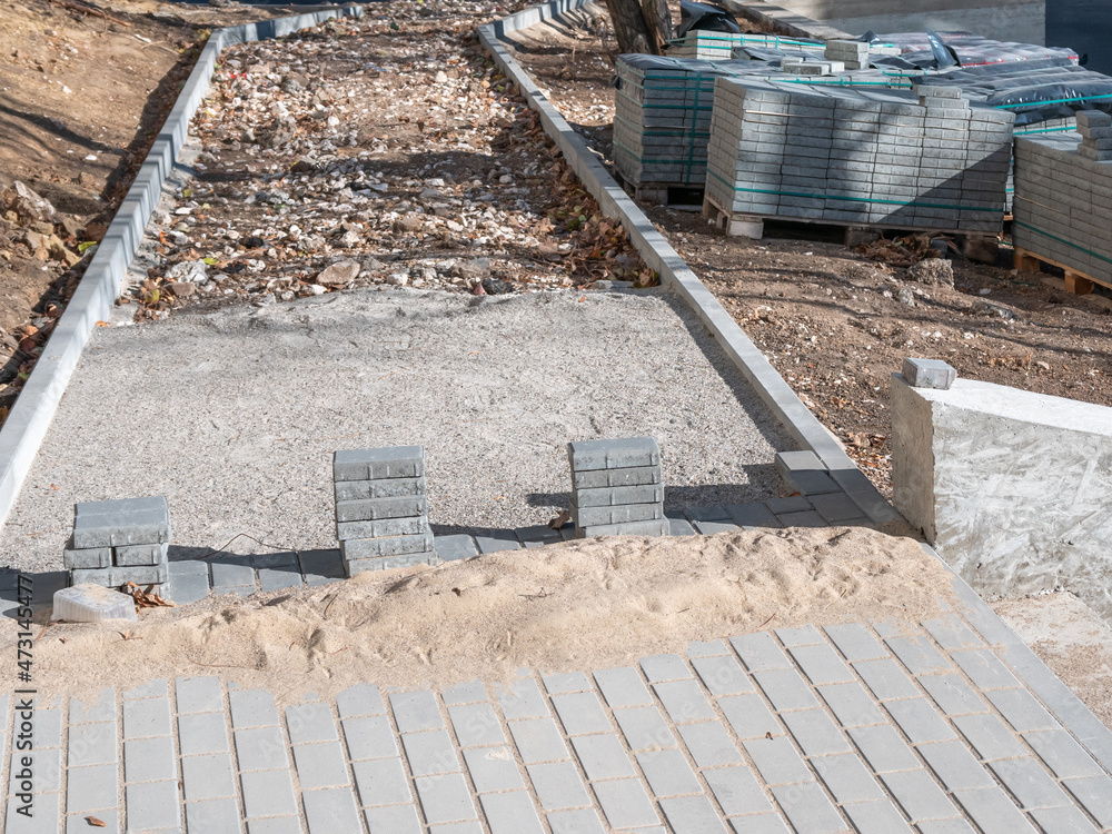 Repair of sidewalks and footpaths. Laying gray paving slabs. Repair of sidewalks and footpaths. Laying gray paving slabs.
