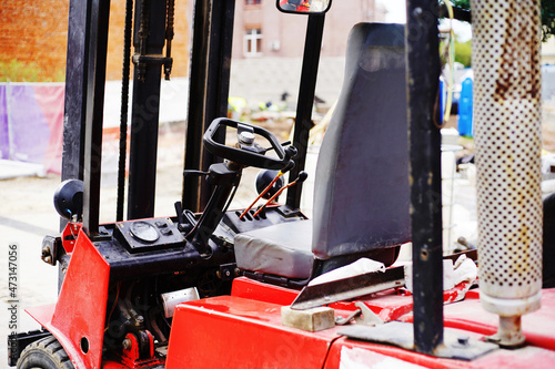 Fragment of a diesel loader with a view of the cab. Construction and cargo transportation equipment. Close-up