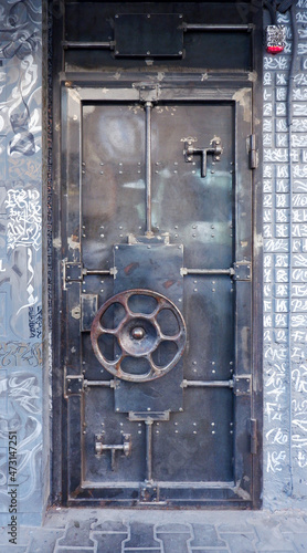unusual iron door with a round handle