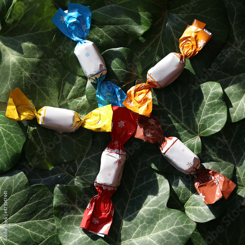  Group of parlour candies on natural green leaves background photo