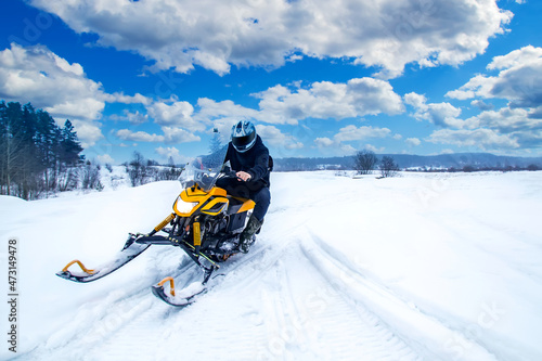 Man rides a snowmobile. Con...