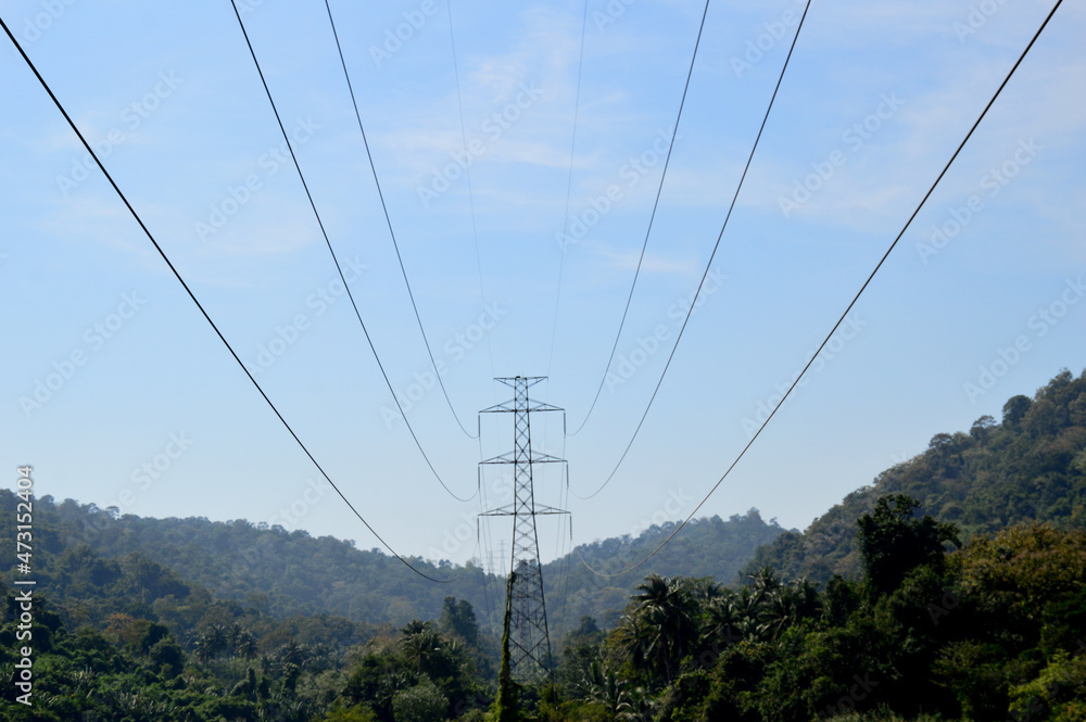 High voltage poles and mountains. Concept of electrical engineering technology.