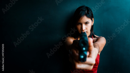 woman in red aiming a gun © battler