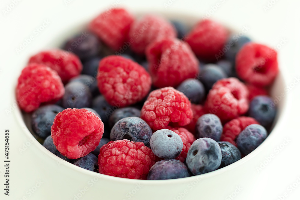 raspberries and blueberries in a bowl raspberries and blueberries in a bowl