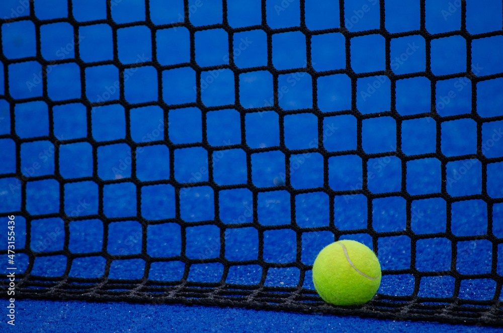 paddle tennis court, a ball by the net