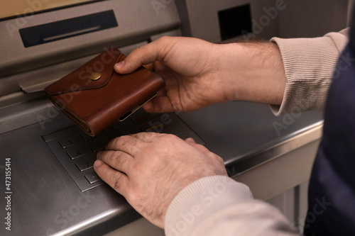 Man entering cash machine pin code, closeup