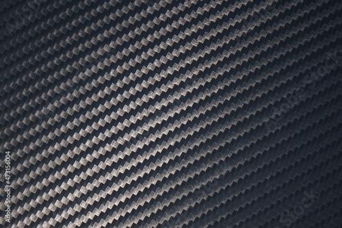 Close up of grey diagonal oriented woven carbon fibre sheet surface. photo