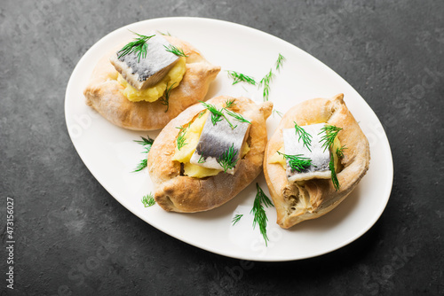 Delicious tapas herring appetizer. Puff pastry boats, mashed potatoes and dill herring slices. Top view. Catering, holiday, picnic