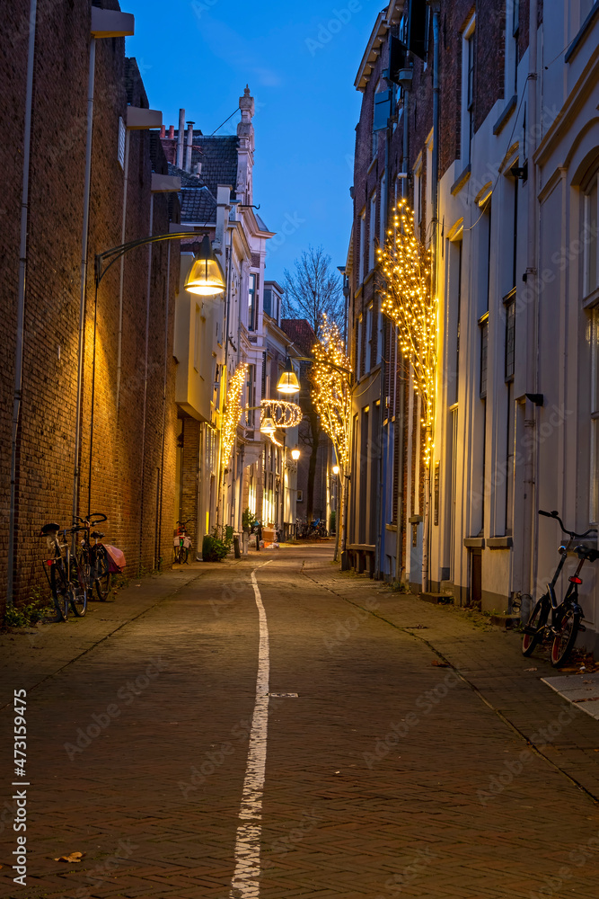 Fototapeta premium Old street in the city center from Deventer in the Netherlands at sunset