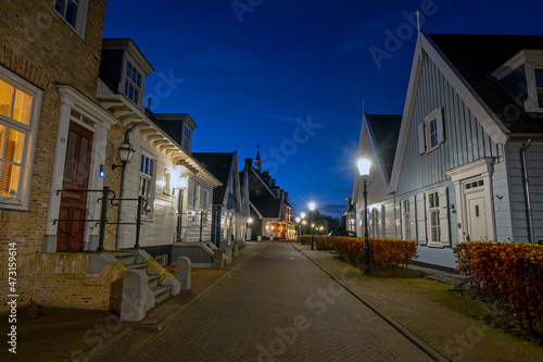 Fototapeta Naklejka Na Ścianę i Meble -  Old dutch wooden houses in Friesland the Netherlands by night in christmas time
