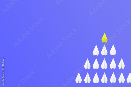 yellow paper plane leading among a white planes on blue background. Business competition and Leadership concept