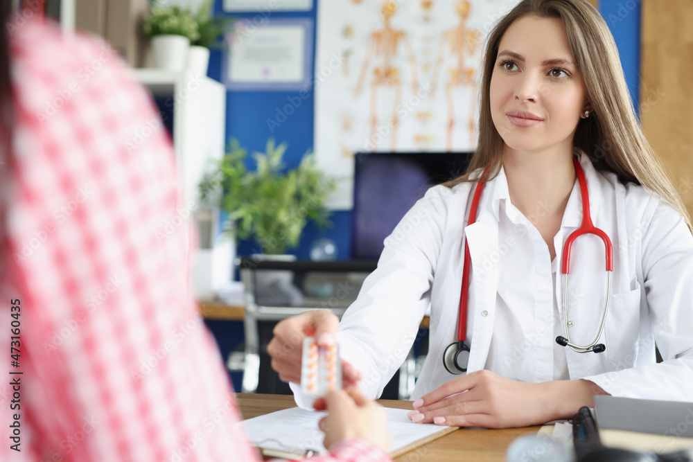 Qualified female doctor give tablets to patient for faster recovery Qualified female doctor give tablets to patient for faster recovery