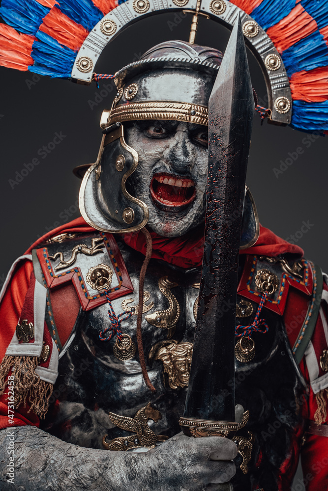 Violent zombie centurion staring at camera isolated on gray
