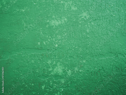 Light green cracked concrete wall texture.