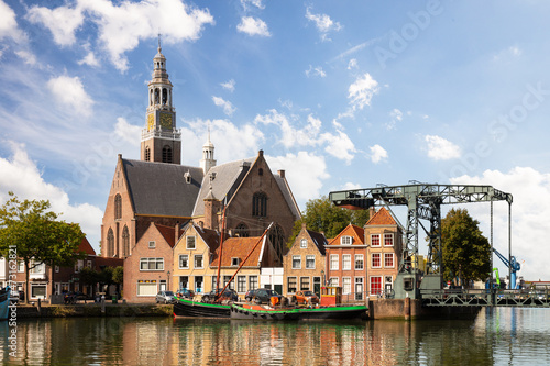 Port of Maassluis with old boats, church, drawbridge and monumental houses. photo
