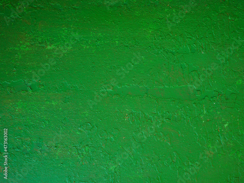 The old light green wooden panels are covered with cracked paint.