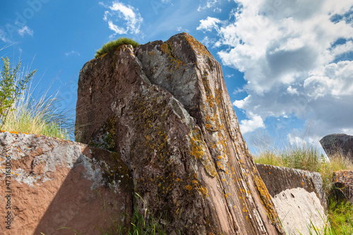 A large, flat-topped ancient rock covered with lichens. Salbyk mound in the steppe of Khakassia. Sights of Khakassia. photo