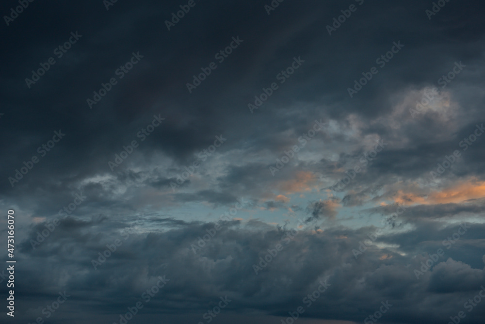 Russia. The South of Eastern Siberia. Gloomy sunset clouds in the evening summer sky over the mountain ranges of Eastern Sayan. Russia. The South of Eastern Siberia. Gloomy sunset clouds in the evening summer sky over the mountain ranges of Eastern Sayan.